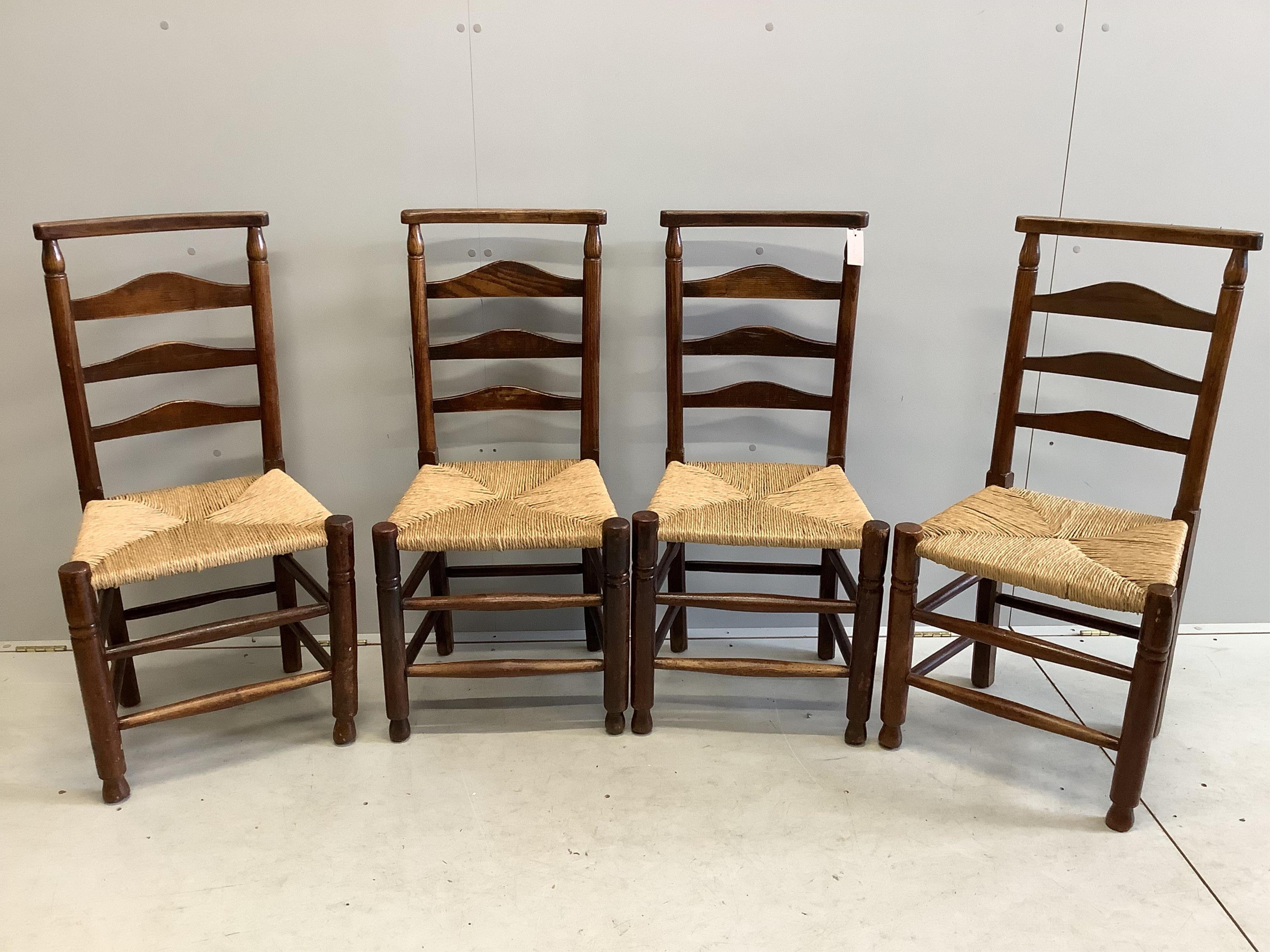 A set of four 19th century ash ladderback rush seat dining chairs. Condition - fair